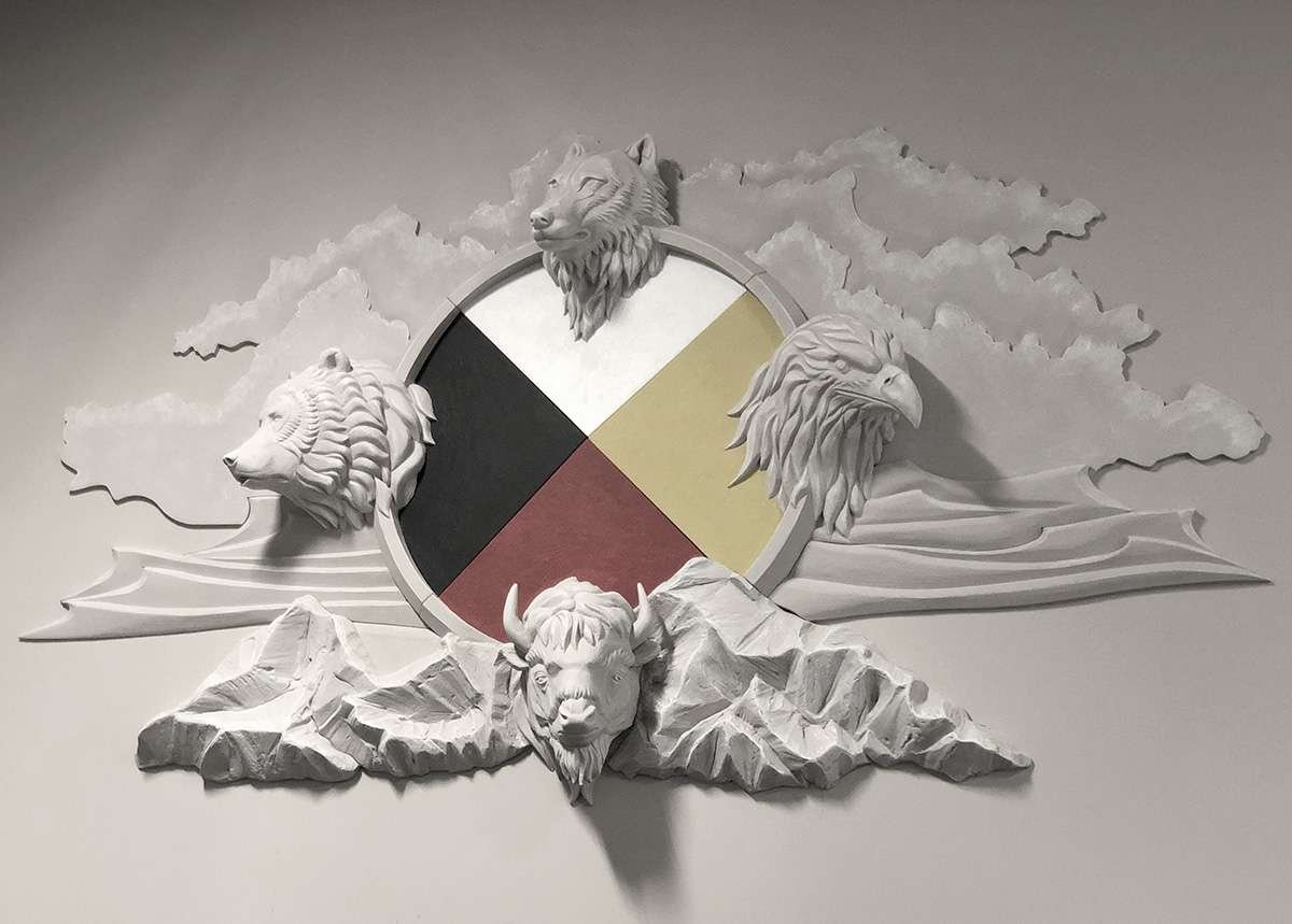 MedicineWheel_Closeup Custom foam sculpture comprised of a medicine wheel and animal sculptures, mounted on a wall.