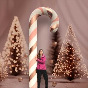 Woman posing with a 12 foot tall Candy Cane