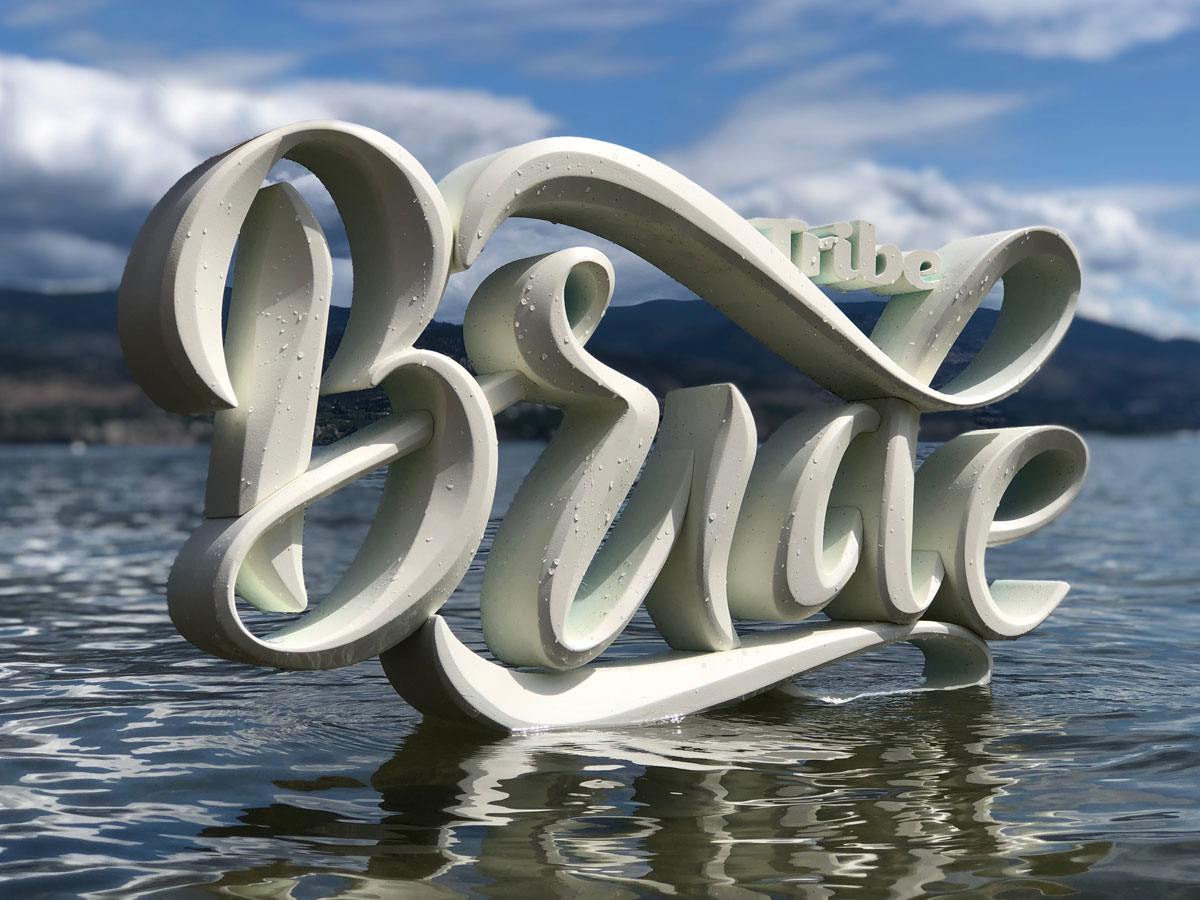 Dimensional sculpted letters reading Bride floating in the okanagan lake.