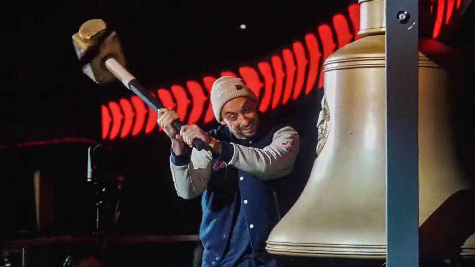 Senators fan hitting a bell with a mallet at the Ottawa Senators game day activation.