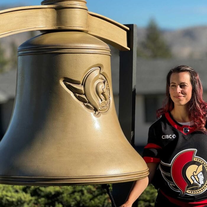 COVER_SENATORS_02 - The Bees Knees Design Ottawa Senators fan posing with a oversized golden bell, event activations.