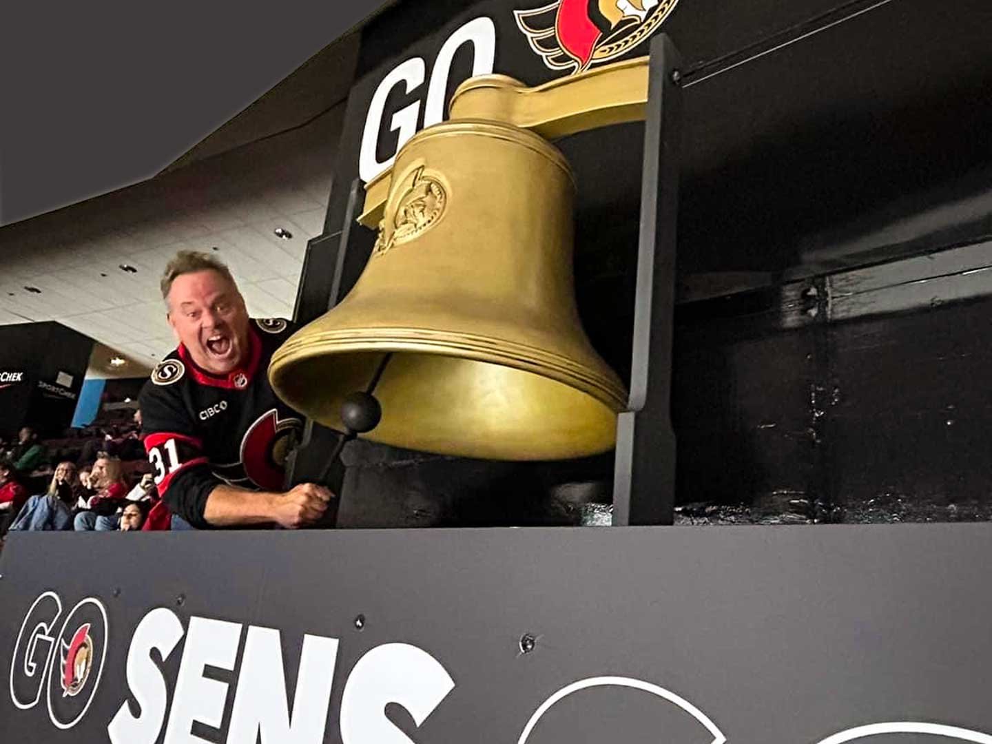 Ottawa Senators fan activation event, fan ringing the bell.
