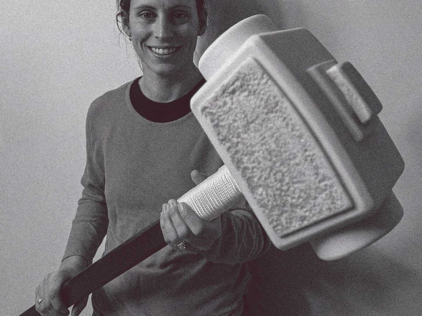Woman holding a custom built mallet prototype.
