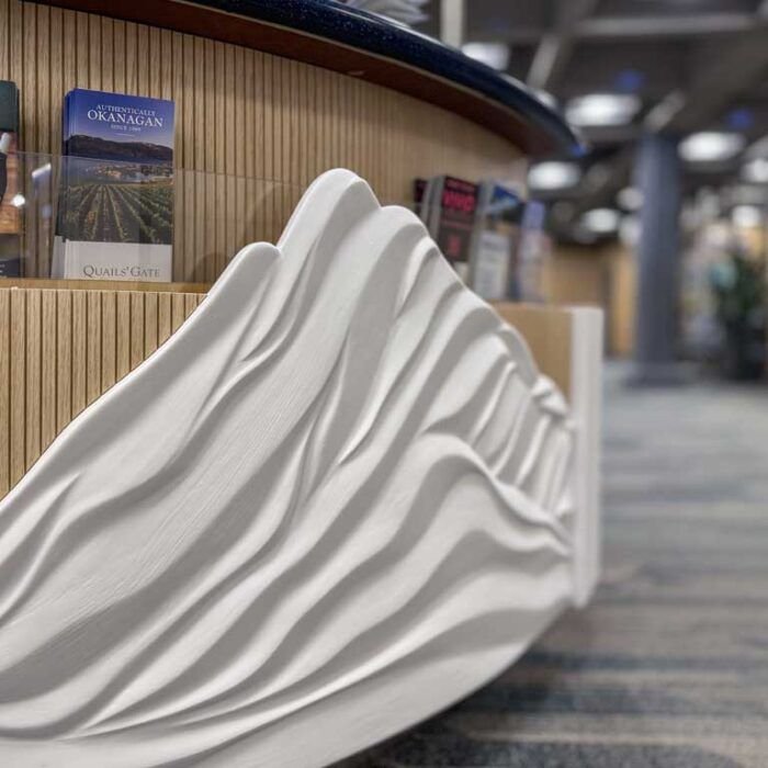 Tourism Kelowna Kiosk - Sculpted Reliefs - Winter - The Bees Knees Design Airport kiosk at the Kelowna International Airport, with curved relief sculptures representing 4 seasons.