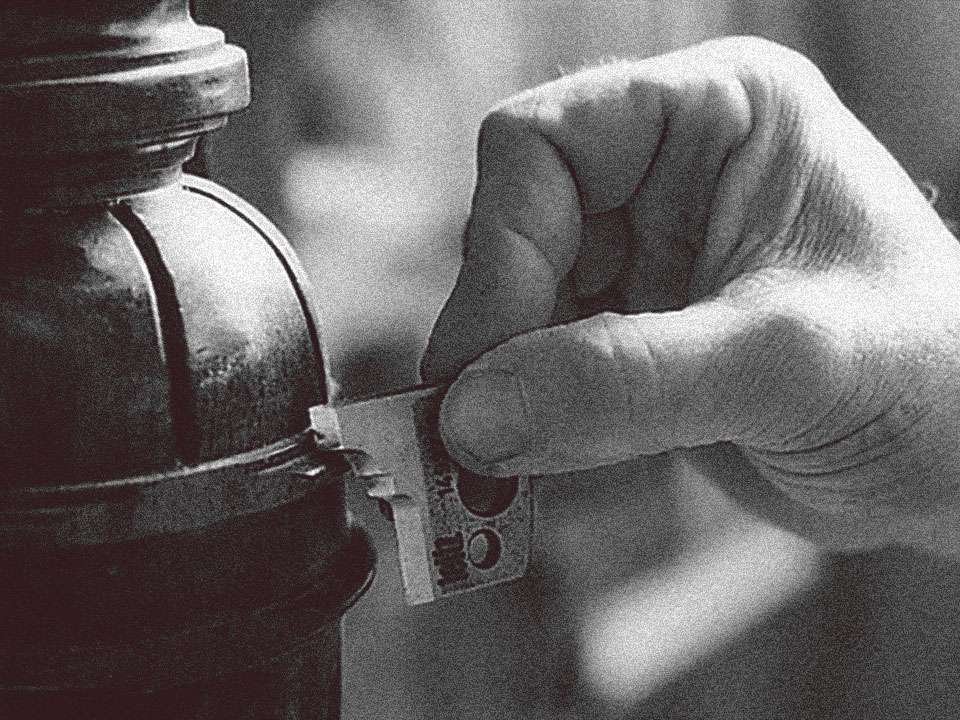 Museum model making, a hand holding a custom router shaper to match a mold on a wooden architectural piece.