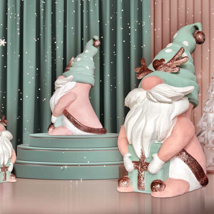 Three pastel-colored gnome figurines with teal hats and white beards around a teal cake stand in a whimsical winter display. custom christmas decoration