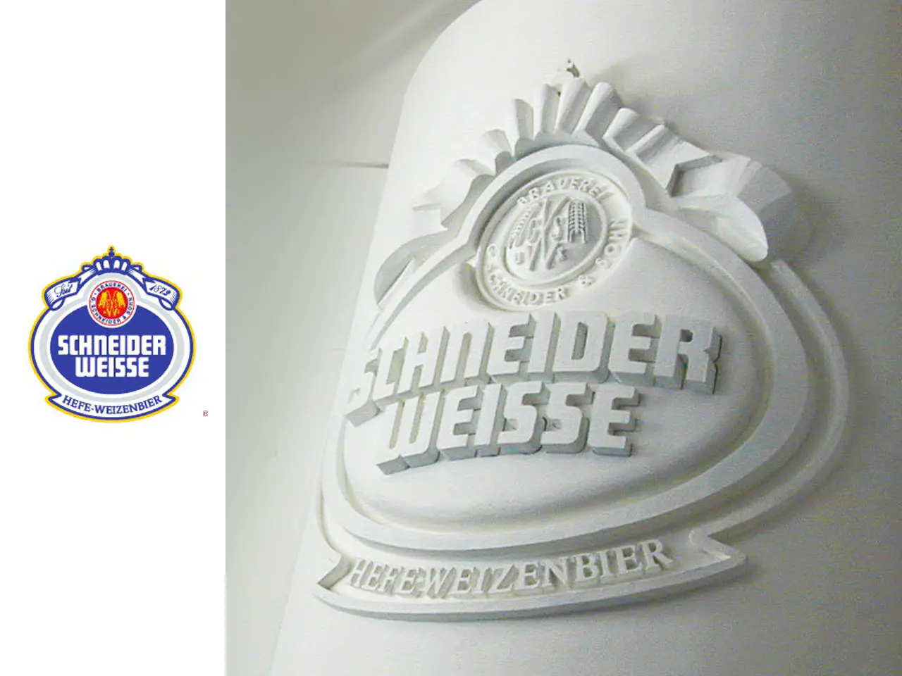 3D_Caroussel_SchneiderWeisse - The Bees Knees Design White embossed Schneider Weisse logo on a wall, with a small blue-and-gold Schneider Weisse crest to the left and the words 'HEFEWEIZENBIER' below.
