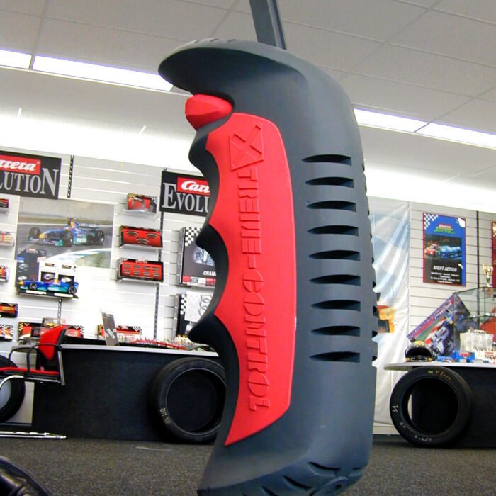 CARERRA3 - The Bees Knees Design Oversized gray and red racing tool sculpture on a stand in a car parts store. 3d replicas