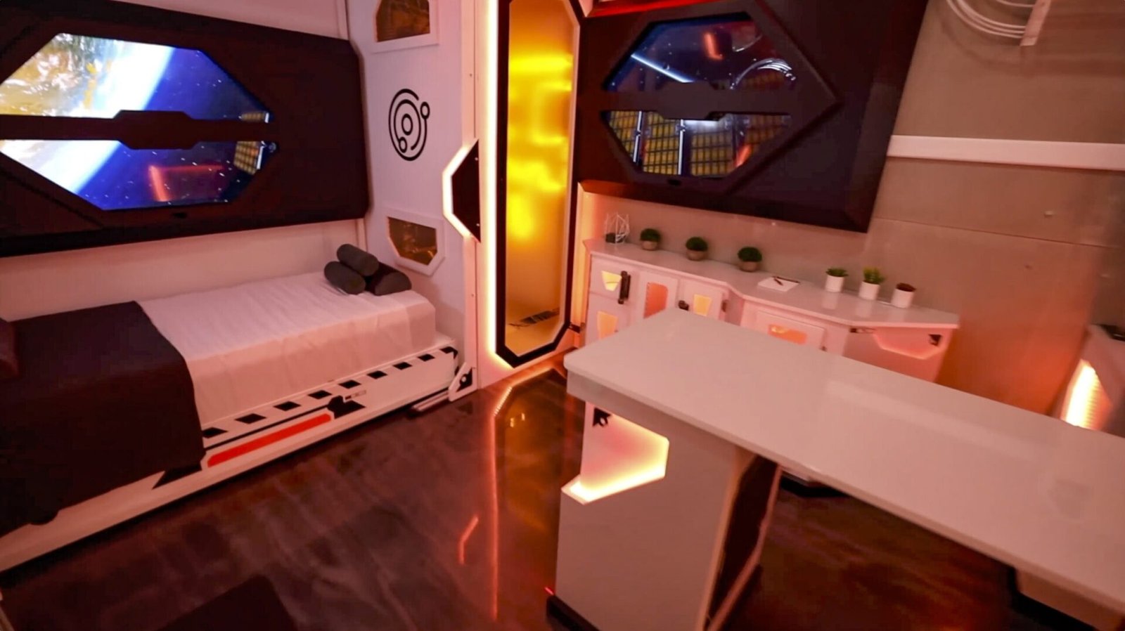 Screenshot Space hotel scenic environments with a bed on the left, white furniture, and warm orange ambient lighting throughout the room.