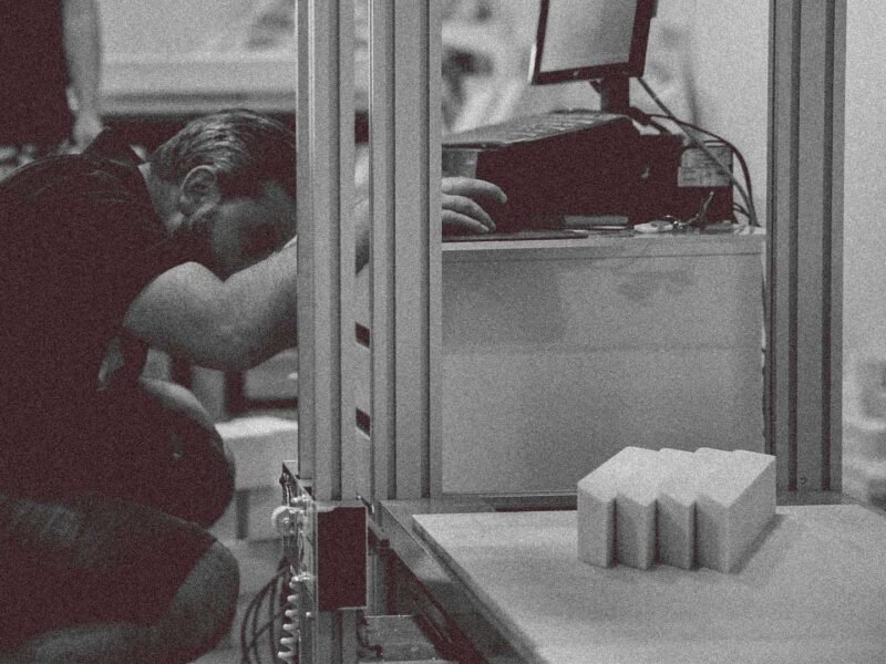 Person working with CNC machinery at a brand activations fabrication facility.