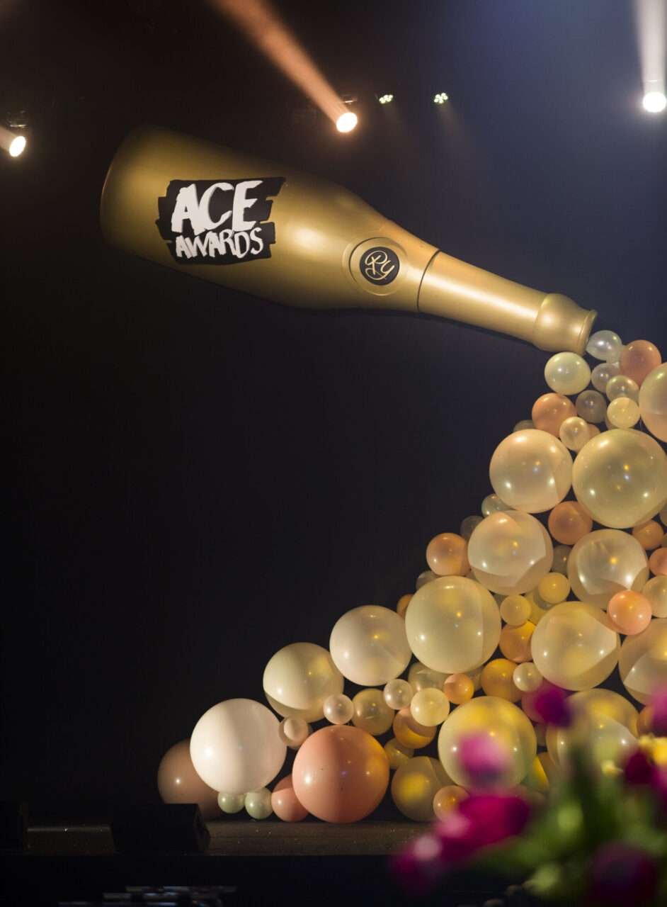 Custom event fabrication for the ACE Awards Gala in Edmonton, balloons pouring out giant champagne bottle..