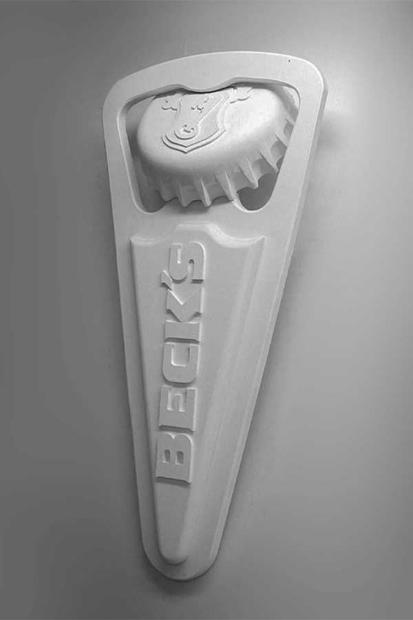 Becks_Replica_1-4 6 feet tall BECK's branded, bottle opener replica mounted on a wall.