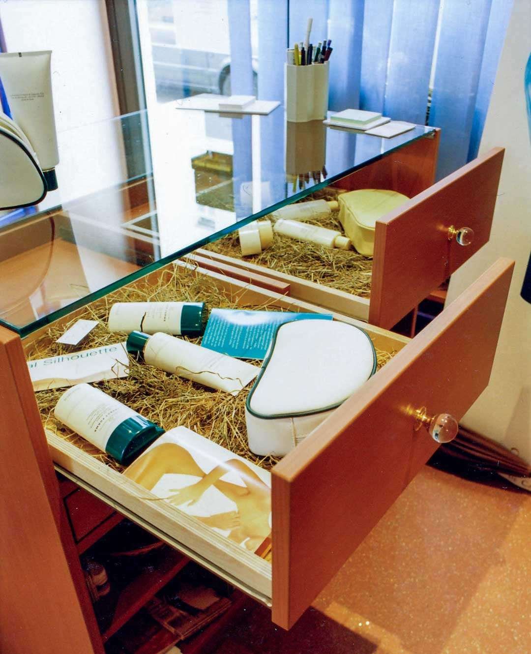 Infinity_Spa_Counter_Display Custom retail displays with glass countertop and open drawers underneath, visible spa products.