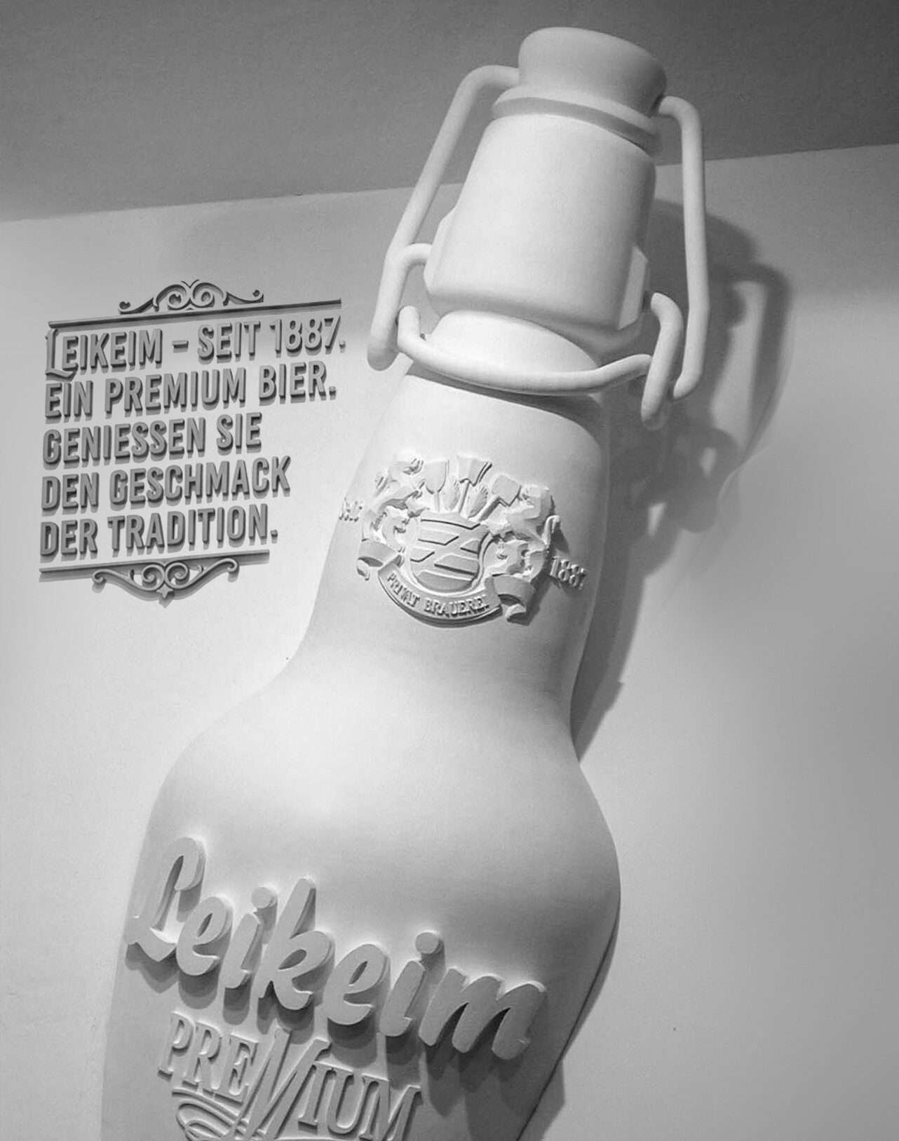 Leikeim_3 8 feet tall Leikeim bottle replica mounted on a wall.