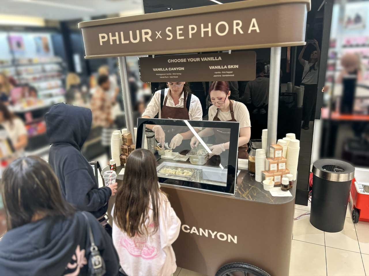 PHLUR_Sephora_Activation_Edmonton_Cart PHLUR Sephora clients in front of a branded promotional cart waiting for ice cream.