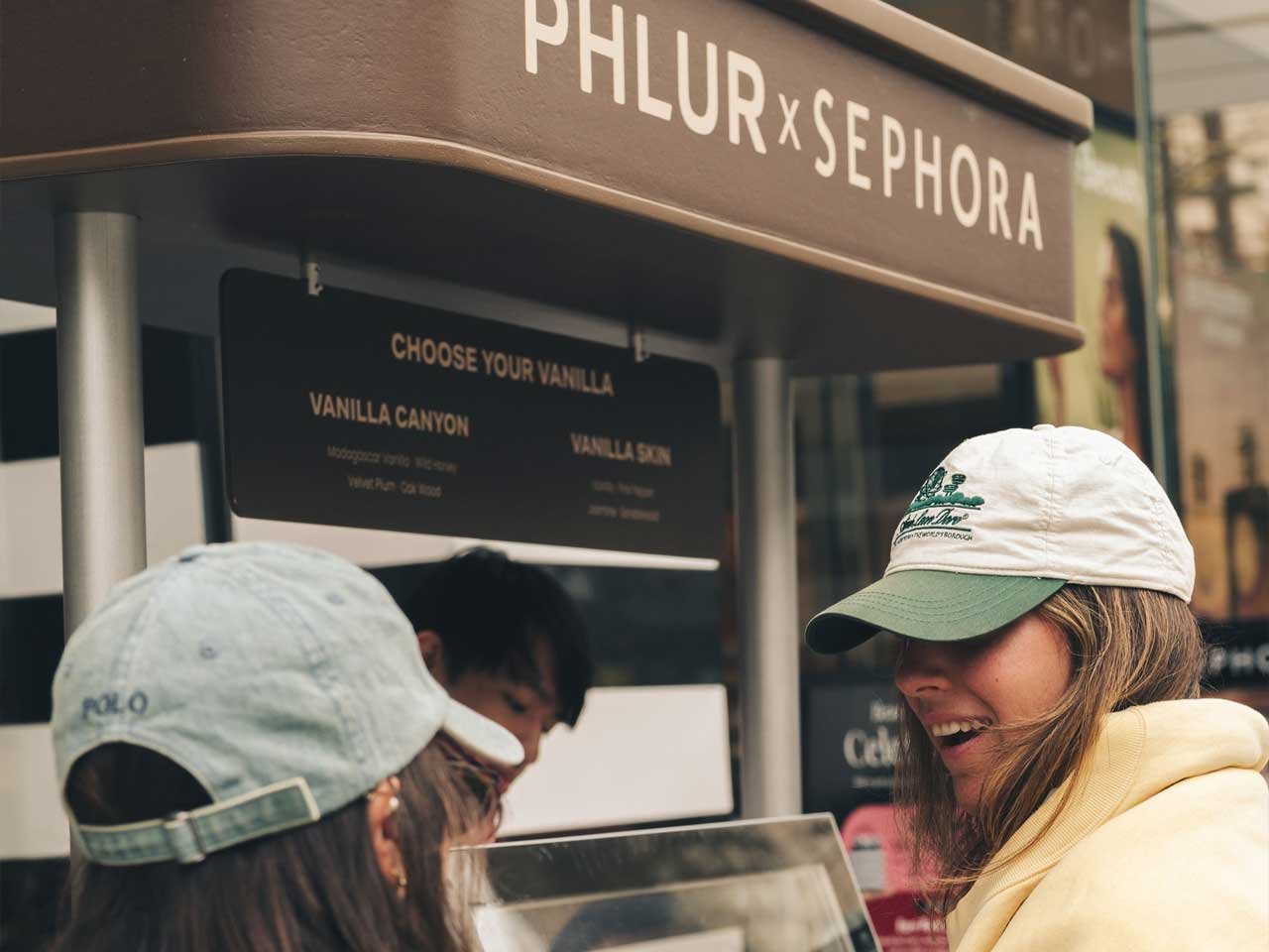 PHLUR_Sephora_Activation_Vancouver_Girls_Testing_Horizontal Two girls in enjoying free ice cream in front at the PHLUR Sephora sampling cart in Vancouver.